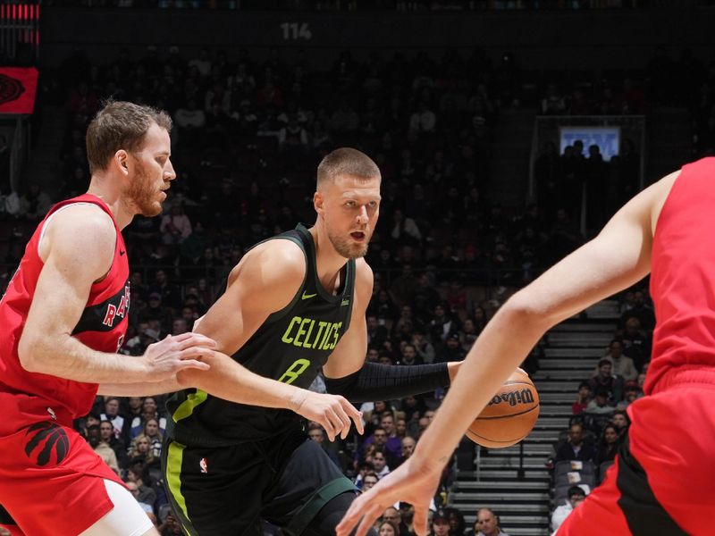 TORONTO, CANADA - JANUARY 15: Kristaps Porzingis #8 of the Boston Celtics dribbles the ball during the game against the Toronto Raptors on January 15, 2025 at the Scotiabank Arena in Toronto, Ontario, Canada.  NOTE TO USER: User expressly acknowledges and agrees that, by downloading and or using this Photograph, user is consenting to the terms and conditions of the Getty Images License Agreement.  Mandatory Copyright Notice: Copyright 2025 NBAE (Photo by Mark Blinch/NBAE via Getty Images)