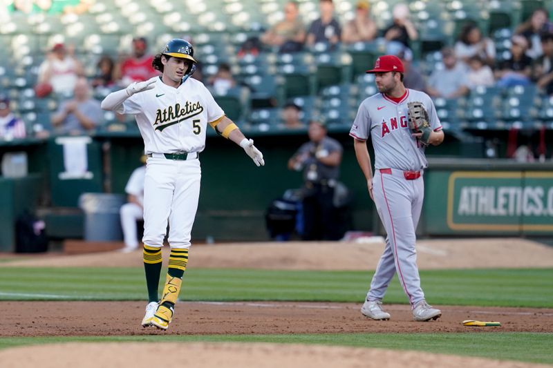 Jul 19, 2024; Oakland, California, USA; Oakland Athletics shortstop Jacob Wilson (5) reacts after collecting his first major league hit against the Los Angeles Angels in the third inning at Oakland-Alameda County Coliseum. Mandatory Credit: Cary Edmondson-USA TODAY Sports