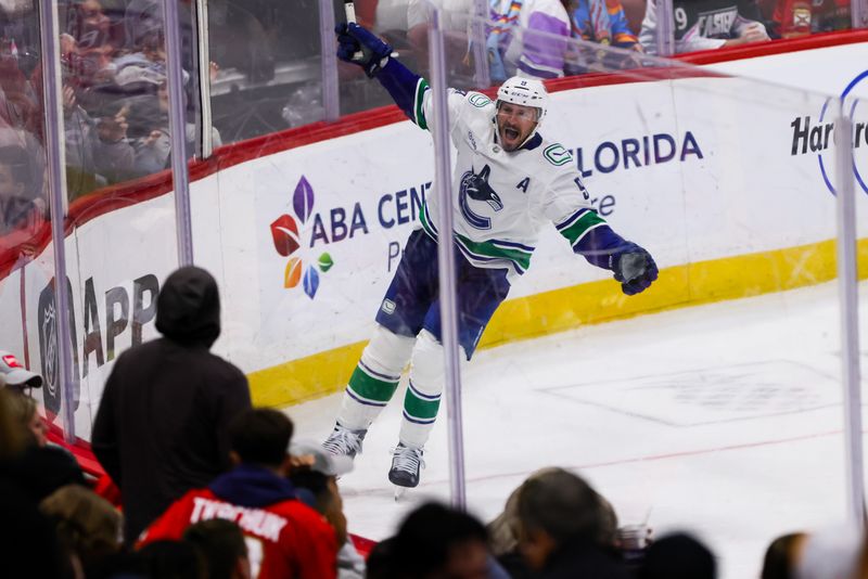 Oct 17, 2024; Sunrise, Florida, USA; Vancouver Canucks center J.T. Miller (9) celebrates after scoring the game-winning goal against the Florida Panthers during overtime at Amerant Bank Arena. Mandatory Credit: Sam Navarro-Imagn Images