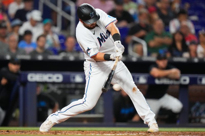 Aug 14, 2023; Miami, Florida, USA; Miami Marlins third baseman Jake Burger (36) hits a single against the Houston Astros during the fourth inning at loanDepot Park. Mandatory Credit: Rich Storry-USA TODAY Sports