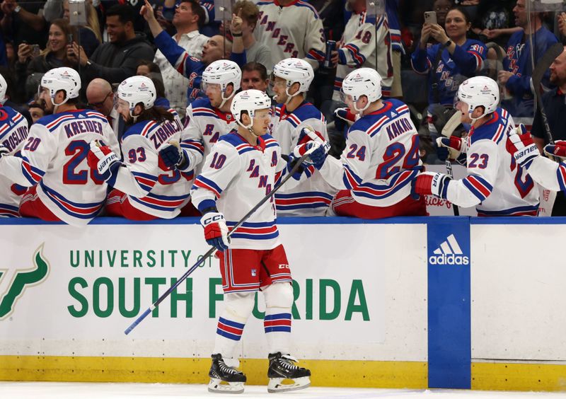 Mar 14, 2024; Tampa, Florida, USA; New York Rangers left wing Artemi Panarin (10) is congratulated after he scored a goal against the Tampa Bay Lightning during the first period at Amalie Arena. Mandatory Credit: Kim Klement Neitzel-USA TODAY Sports