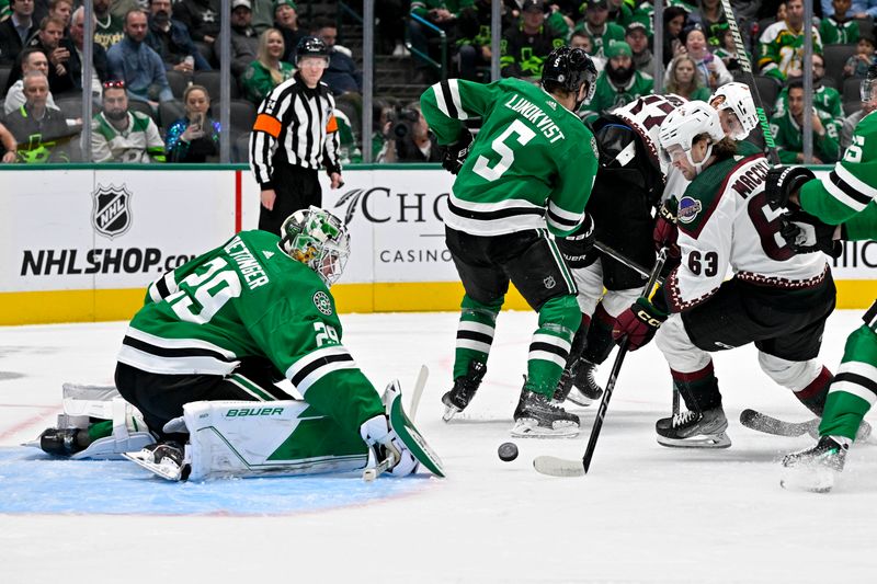 Nov 14, 2023; Dallas, Texas, USA; Dallas Stars goaltender Jake Oettinger (29) stops a shot by Arizona Coyotes left wing Matias Maccelli (63) during the first period at the American Airlines Center. Mandatory Credit: Jerome Miron-USA TODAY Sports