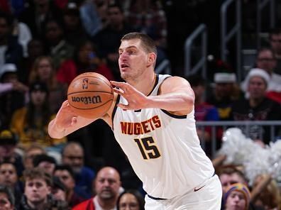 DENVER, CO - DECEMBER 25: Nikola Jokic #15 of the Denver Nuggets passes the ball during the game against the Golden State Warriors on December 25, 2023 at the Ball Arena in Denver, Colorado. NOTE TO USER: User expressly acknowledges and agrees that, by downloading and/or using this Photograph, user is consenting to the terms and conditions of the Getty Images License Agreement. Mandatory Copyright Notice: Copyright 2023 NBAE (Photo by Garrett Ellwood/NBAE via Getty Images)