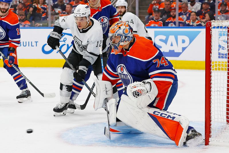 Apr 22, 2024; Edmonton, Alberta, CAN; Los Angeles Kings forward Trevor Moore (12) looks for a rebound in front of Edmonton Oilers goaltender Stuart Skinner (74) during the second period in game one of the first round of the 2024 Stanley Cup Playoffs at Rogers Place. Mandatory Credit: Perry Nelson-USA TODAY Sports