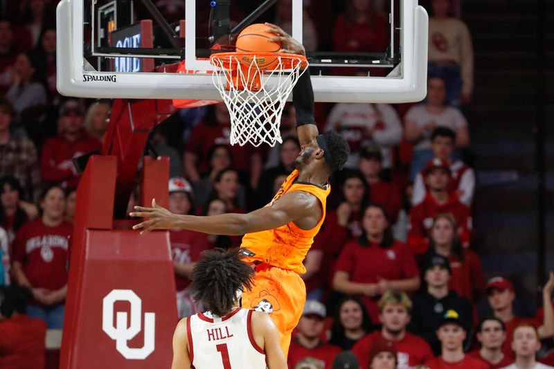 Feb 1, 2023; Norman, Oklahoma, USA; Oklahoma State Cowboys forward Moussa Cisse (33) dunks in front of Oklahoma Sooners forward Jalen Hill (1) during the second half at Lloyd Noble Center. Mandatory Credit: Alonzo Adams-USA TODAY Sports