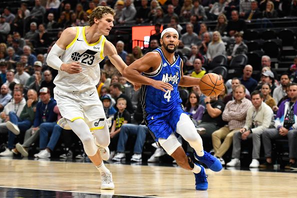 SALT LAKE CITY, UTAH - NOVEMBER 02: Lauri Markkanen #23 of the Utah Jazz defends Jalen Suggs #4 of the Orlando Magic during the second half of a game at Delta Center on November 02, 2023 in Salt Lake City, Utah. NOTE TO USER: User expressly acknowledges and agrees that, by downloading and or using this photograph, User is consenting to the terms and conditions of the Getty Images License Agreement.  (Photo by Alex Goodlett/Getty Images)