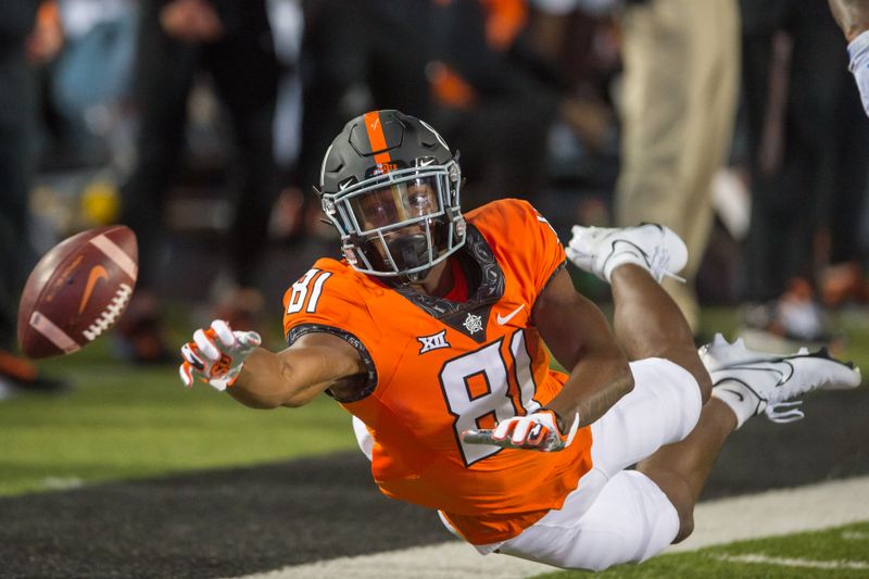 Oct 30, 2021; Stillwater, Oklahoma, USA;  Oklahoma State Cowboys wide receiver CJ Tate (81) can   t pull in the reception during the fourth quarter against Kansas Jayhawks at Boone Pickens Stadium. Oklahoma State won 55-3. Mandatory Credit: Brett Rojo-USA TODAY Sports