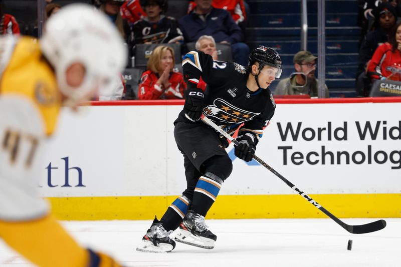 Nov 6, 2024; Washington, District of Columbia, USA; Washington Capitals defenseman Martin Fehervary (42) skates with the puck as Nashville Predators right wing Michael McCarron (47) chases in the second period at Capital One Arena. Mandatory Credit: Geoff Burke-Imagn Images