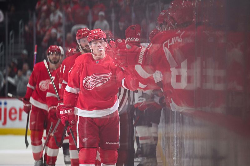 Feb 27, 2024; Detroit, Michigan, USA; Detroit Red Wings left wing Lucas Raymond (23) celebrates his goal with teammates during the first period against the Washington Capitals at Little Caesars Arena. Mandatory Credit: Tim Fuller-USA TODAY Sports