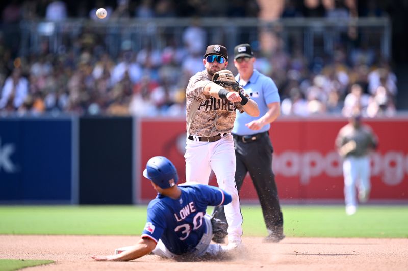 Jul 30, 2023; San Diego, California, USA; San Diego Padres second baseman Matthew Batten (17) throws to first base after forcing out Texas Rangers first baseman Nate Lowe (30) at second base to complete a double play during the seventh inning at Petco Park. Mandatory Credit: Orlando Ramirez-USA TODAY Sports