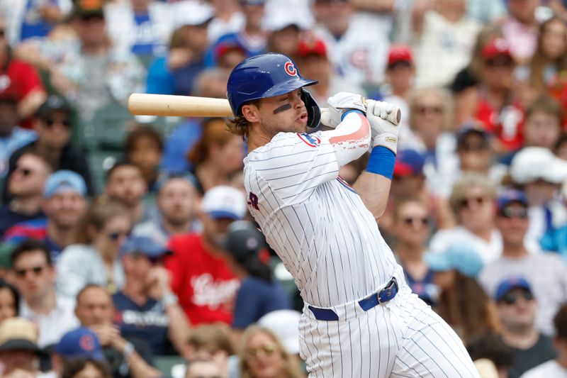 Jul 4, 2024; Chicago, Illinois, USA; Chicago Cubs second baseman Nico Hoerner (2) hits an RBI-single against the Philadelphia Phillies during the fourth inning at Wrigley Field. Mandatory Credit: Kamil Krzaczynski-USA TODAY Sports