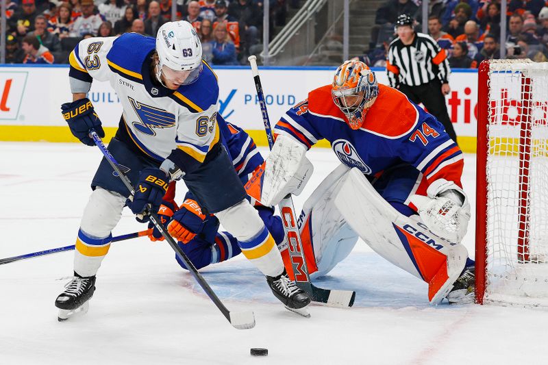 Feb 28, 2024; Edmonton, Alberta, CAN; St. Louis Blues forward Jake Neighbours (63) tries to get a shot away on Edmonton Oilers goaltender Stuart Skinner (74) during the second period at Rogers Place. Mandatory Credit: Perry Nelson-USA TODAY Sports