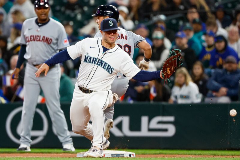 Apr 2, 2024; Seattle, Washington, USA; Seattle Mariners first baseman Ty France (23) fails to catch a throwing error  by third baseman Josh Rojas (4, not pictured) against the Cleveland Guardians allowing a run to score during the fifth inning at T-Mobile Park. Mandatory Credit: Joe Nicholson-USA TODAY Sports