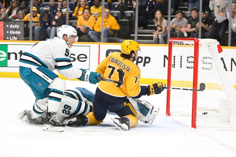 Oct 21, 2023; Nashville, Tennessee, USA; Nashville Predators right wing Luke Evangelista (77) scores past San Jose Sharks goaltender Mackenzie Blackwood (29) during the third period at Bridgestone Arena. Mandatory Credit: Steve Roberts-USA TODAY Sports