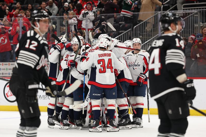 Dec 27, 2025; Newark, New Jersey, USA; The Washington Capitals celebrate their overtime win over the New Jersey Devils at Prudential Center. Mandatory Credit: Ed Mulholland-Imagn Images