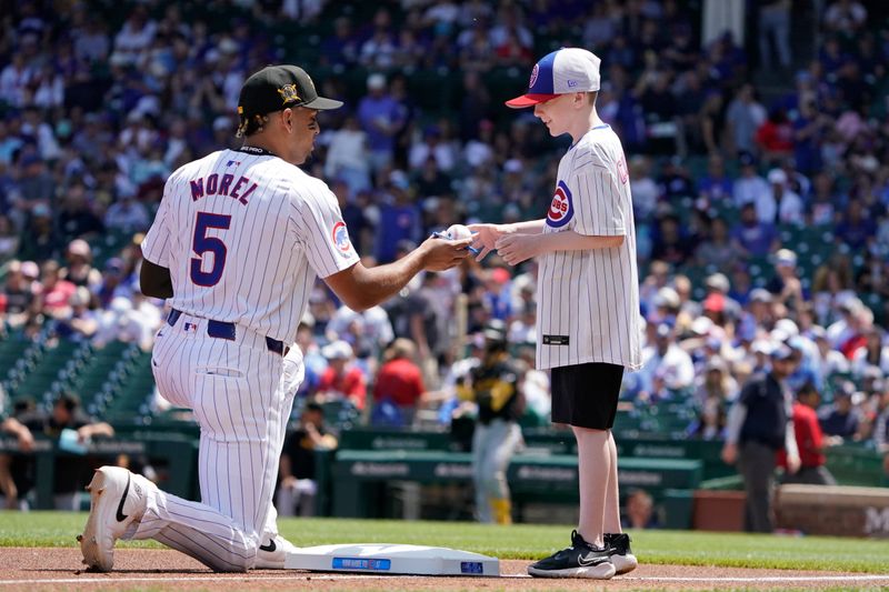 May 19, 2024; Chicago, Illinois, USA; Chicago Cubs third base Christopher Morel (5) signs an autograph before the game against the Pittsburgh Pirates at Wrigley Field. Mandatory Credit: David Banks-USA TODAY Sports