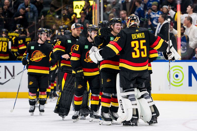 Dec 12, 2023; Vancouver, British Columbia, CAN; Vancouver Canucks defenseman Quinn Hughes (43) and forward Brock Boeser (6) and goalie Thatcher Demko (35) celebrate their victroy against the Tampa Bay Lightning at Rogers Arena. Vancouver won 4-1. Mandatory Credit: Bob Frid-USA TODAY Sports