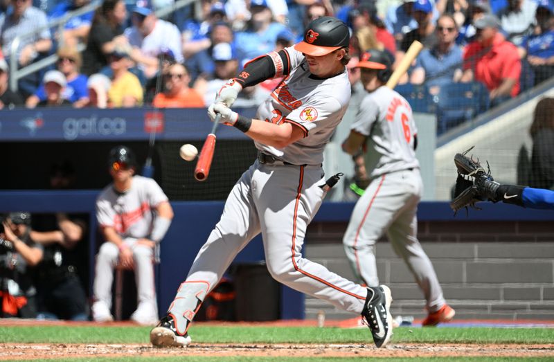 Jun 6, 2024; Toronto, Ontario, CAN;    Baltimore Orioles designated hitter Adley Rutschman (35) hits a two run home run against the Toronto Blue Jays in the eighth inning at Rogers Centre. Mandatory Credit: Dan Hamilton-USA TODAY Sports