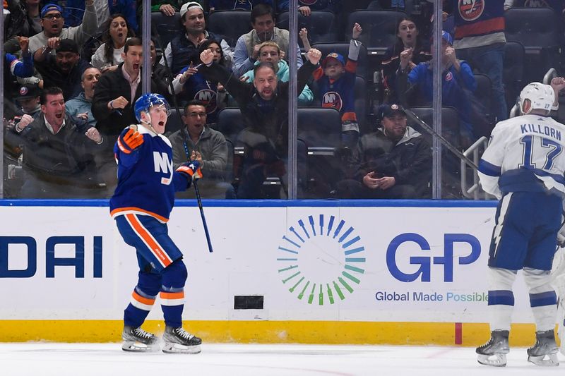 Apr 6, 2023; Elmont, New York, USA; New York Islanders right wing Simon Holmstrom (10) celebrates his goal against the Tampa Bay Lightning during the third period at UBS Arena. Mandatory Credit: Dennis Schneidler-USA TODAY Sports
