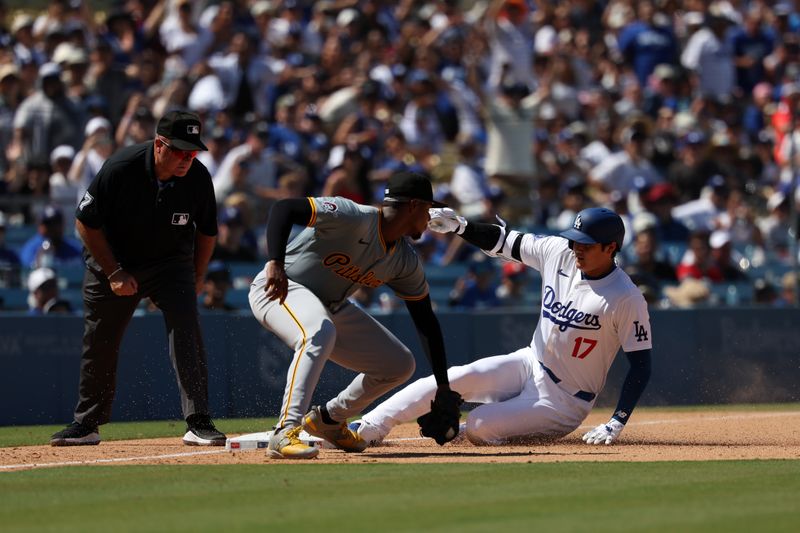 Aug 11, 2024; Los Angeles, California, USA;  Los Angeles Dodgers designated hitter Shohei Ohtani (17) is safe at third base with a triple ahead of the tag by Pittsburgh Pirates third baseman Ke'Bryan Hayes (13)  during the sixth inning against the Pittsburgh Pirates at Dodger Stadium. Mandatory Credit: Kiyoshi Mio-USA TODAY Sports
