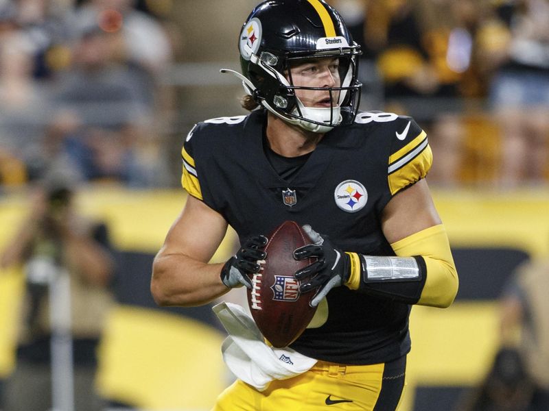 Pittsburgh Steelers quarterback Kenny Pickett (8) rolls out to pass during a preseason NFL football game, Saturday, Aug. 13, 2022, in Pittsburgh, PA. (AP Photo/Matt Durisko)