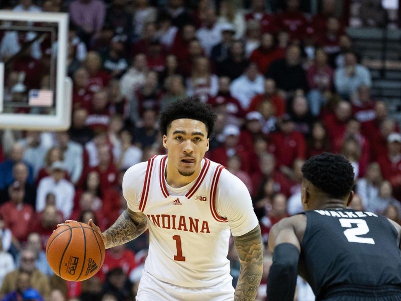 Jan 22, 2023; Bloomington, Indiana, USA; Indiana Hoosiers guard Jalen Hood-Schifino (1) dribbles  the ball while Michigan State Spartans guard Tyson Walker (2) defends in the first half at Simon Skjodt Assembly Hall. Mandatory Credit: Trevor Ruszkowski-USA TODAY Sports