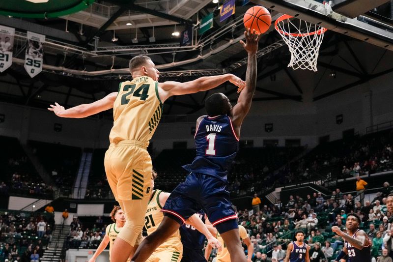 Jan 6, 2024; Charlotte, North Carolina, USA; Florida Atlantic Owls guard Johnell Davis (1) goes up for the basket defended by Charlotte 49ers forward Igor Milicic Jr. (24) during the second half at Dale F. Halton Arena. Mandatory Credit: Jim Dedmon-USA TODAY Sports