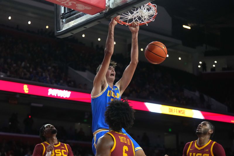 Jan 27, 2025; Los Angeles, California, USA; UCLA Bruins center Aday Mara (15) dunks the ball against the Southern California Trojans in the first half at Galen Center. Mandatory Credit: Kirby Lee-Imagn Images