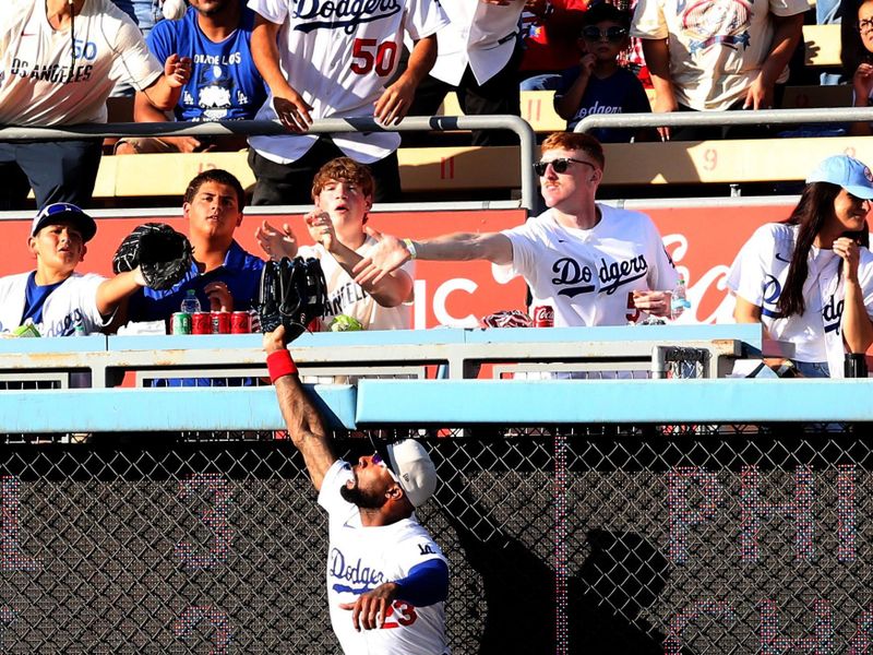 Jul 4, 2024; Los Angeles, California, USA; Los Angeles Dodgers outfielder Jason Heyward (23) leaps for a home run hit by Arizona Diamondbacks designated hitter Joc Pederson (not pictured) during the first inning at Dodger Stadium. Mandatory Credit: Jason Parkhurst-USA TODAY Sports