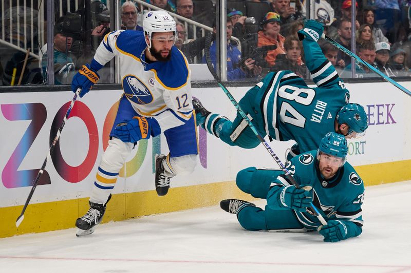 Jan 27, 2024; San Jose, California, USA; San Jose Sharks defenseman Jan Rutta (84) and center Ryan Carpenter (22) fall to the ice against Buffalo Sabres left wing Jordan Greenway (12) during the first period at SAP Center at San Jose. Mandatory Credit: Robert Edwards-USA TODAY Sports