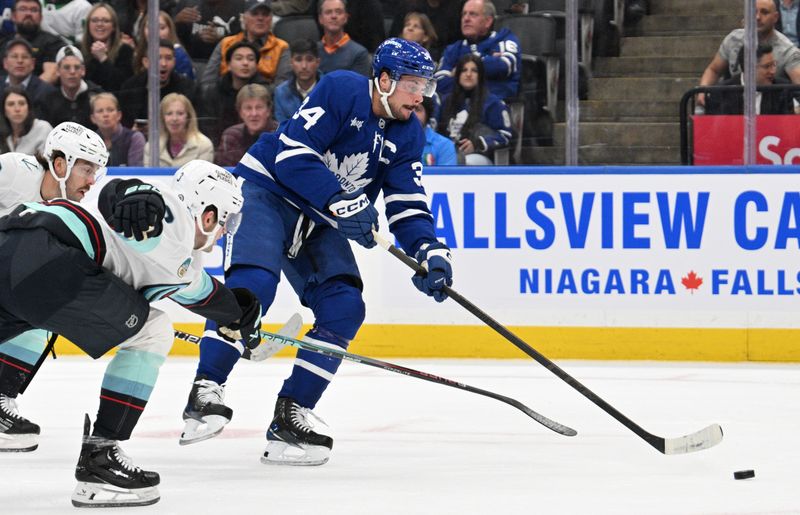 Oct 31, 2024; Toronto, Ontario, CAN;  Toronto Maple Leafs forward Auston Matthews (34) shoots the puck against the Seattle Kraken in the first period at Scotiabank Arena. Mandatory Credit: Dan Hamilton-Imagn Images