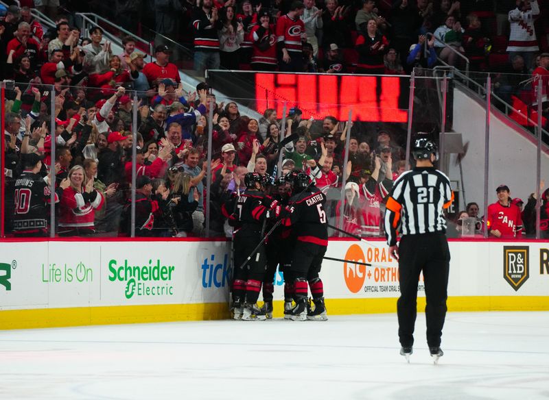 Mar 14, 2024; Raleigh, North Carolina, USA; Carolina Hurricanes center Evgeny Kuznetsov (92) is congratulated by defenseman Jalen Chatfield (5) and defenseman Dmitry Orlov (7) after his goal against the Florida Panthers during the second period at PNC Arena. Mandatory Credit: James Guillory-USA TODAY Sports