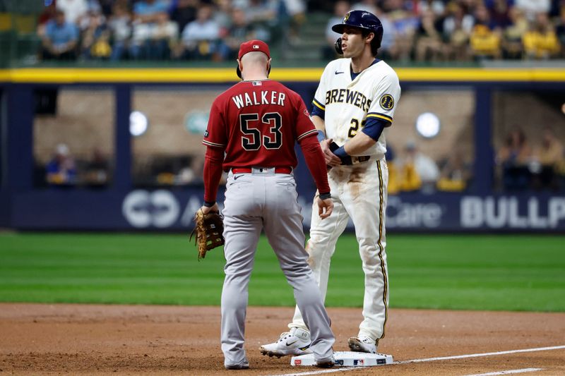 Oct 4, 2023; Milwaukee, Wisconsin, USA; Milwaukee Brewers left fielder Christian Yelich (22) reacts on first base against Arizona Diamondbacks first baseman Christian Walker (53) in the first inning during game two of the Wildcard series for the 2023 MLB playoffs at American Family Field. Mandatory Credit: Kamil Krzaczynski-USA TODAY Sports