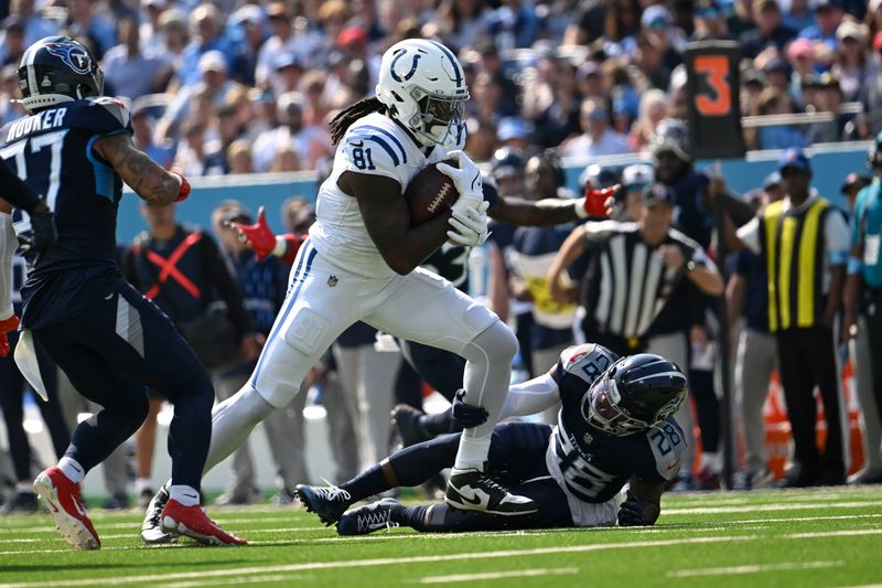 Indianapolis Colts tight end Mo Alie-Cox (81) is tackled by Tennessee Titans safety Quandre Diggs (28) during the first half of an NFL football game, Sunday, Oct. 13, 2024, in Nashville, Tenn. (AP Photo/John Amis)