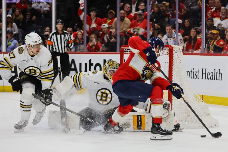 May 8, 2024; Sunrise, Florida, USA; Florida Panthers center Carter Verhaeghe (23) shoots the puck against Boston Bruins goaltender Jeremy Swayman (1) during the first period in game two of the second round of the 2024 Stanley Cup Playoffs at Amerant Bank Arena. Mandatory Credit: Sam Navarro-USA TODAY Sports