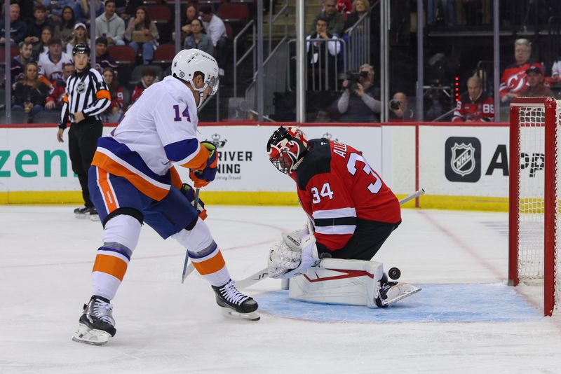 Oct 25, 2024; Newark, New Jersey, USA; New Jersey Devils goaltender Jake Allen (34) makes a save on New York Islanders center Bo Horvat (14) during the first period at Prudential Center. Mandatory Credit: Ed Mulholland-Imagn Images