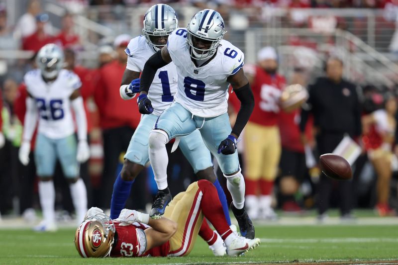 Dallas Cowboys safety Donovan Wilson (6) reacts after hitting San Francisco 49ers running back Christian McCaffrey (23) during the first half of an NFL football game in Santa Clara, Calif., Sunday, Oct. 8, 2023. (AP Photo/Jed Jacobsohn)