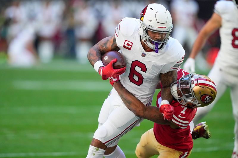 Arizona Cardinals running back James Conner (6) runs against San Francisco 49ers cornerback Charvarius Ward (7) during the first half of an NFL football game, Sunday, Dec. 17, 2023, in Glendale, Ariz. (AP Photo/Matt York)