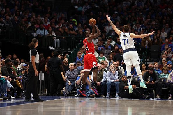 DALLAS, TEXAS - NOVEMBER 01: Patrick Williams #44 of the Chicago Bulls shoots the ball against Luka Doncic #77 of the Dallas Mavericks in the first half at American Airlines Center on November 01, 2023 in Dallas, Texas. NOTE TO USER: User expressly acknowledges and agrees that, by downloading and or using this photograph, User is consenting to the terms and conditions of the Getty Images License Agreement. (Photo by Tim Heitman/Getty Images)