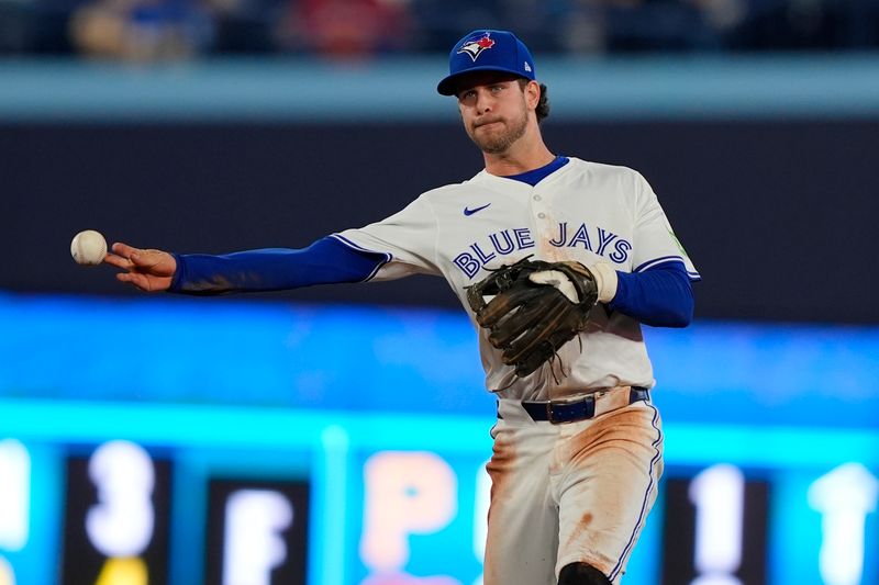 Sep 10, 2025; Toronto, Ontario, CAN; Toronto Blue Jays shortstop Ernie Clement (22) throws out Houston Astros left fielder Yordan Alvarez (not pictured) at first base during the sixth inning at Rogers Centre. Mandatory Credit: John E. Sokolowski-Imagn Images