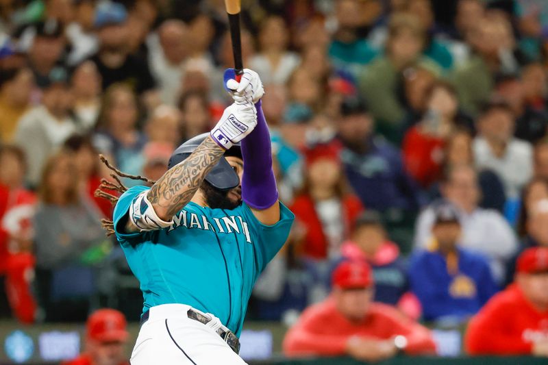 Sep 12, 2023; Seattle, Washington, USA; Seattle Mariners shortstop J.P. Crawford (3) hits a three-run double against the Los Angeles Angels during the fourth inning at T-Mobile Park. Mandatory Credit: Joe Nicholson-USA TODAY Sports