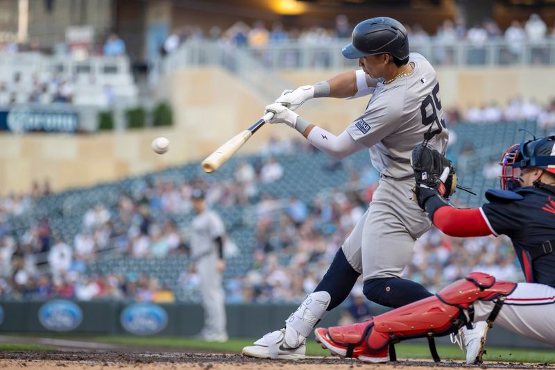 May 14, 2024; Minneapolis, Minnesota, USA; New York Yankees third baseman Oswaldo Cabrera (95) hits a RBI fly ball against the Minnesota Twins in the second inning at Target Field. Mandatory Credit: Jesse Johnson-USA TODAY Sports