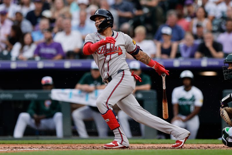 Aug 10, 2024; Denver, Colorado, USA; Atlanta Braves shortstop Orlando Arcia (11) this a single in the third inning against the Colorado Rockies at Coors Field. Mandatory Credit: Isaiah J. Downing-USA TODAY Sports