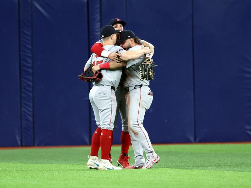 May 20, 2024; St. Petersburg, Florida, USA;  Boston Red Sox outfielder Tyler O'Neill (17), outfielder Jarren Duran (16) and outfielder Wilyer Abreu (52) celebrate after they beat the Tampa Bay Rays at Tropicana Field. Mandatory Credit: Kim Klement Neitzel-USA TODAY Sports