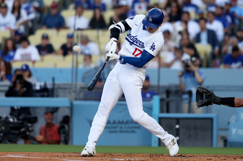 Jul 2, 2024; Los Angeles, California, USA;  Los Angeles Dodgers designated hitter Shohei Ohtani (17) hits a double during the first inning against the Arizona Diamondbacks at Dodger Stadium. Mandatory Credit: Kiyoshi Mio-USA TODAY Sports