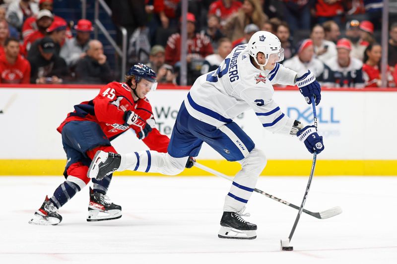 Oct 24, 2023; Washington, District of Columbia, USA; Toronto Maple Leafs defenseman John Klingberg (3) passes the puck as Washington Capitals center Matthew Phillips (45) chases in the third period at Capital One Arena. Mandatory Credit: Geoff Burke-USA TODAY Sports