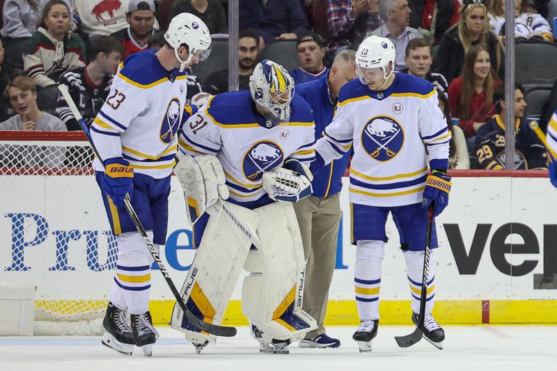 Oct 27, 2023; Newark, New Jersey, USA; Buffalo Sabres goaltender Eric Comrie (31) skates off the ice with teammates after an injury during the second period against the New Jersey Devils at Prudential Center. Mandatory Credit: Vincent Carchietta-USA TODAY Sports