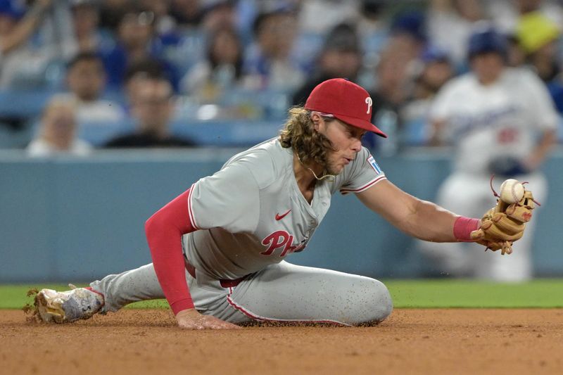 Aug 5, 2024; Los Angeles, California, USA;  Philadelphia Phillies third baseman Alec Bohm (28) makes a play off a ground ball hit by Los Angeles Dodgers shortstop Nick Ahmed (12) and throws him out at first base in the eighth inning at Dodger Stadium. Mandatory Credit: Jayne Kamin-Oncea-USA TODAY Sports