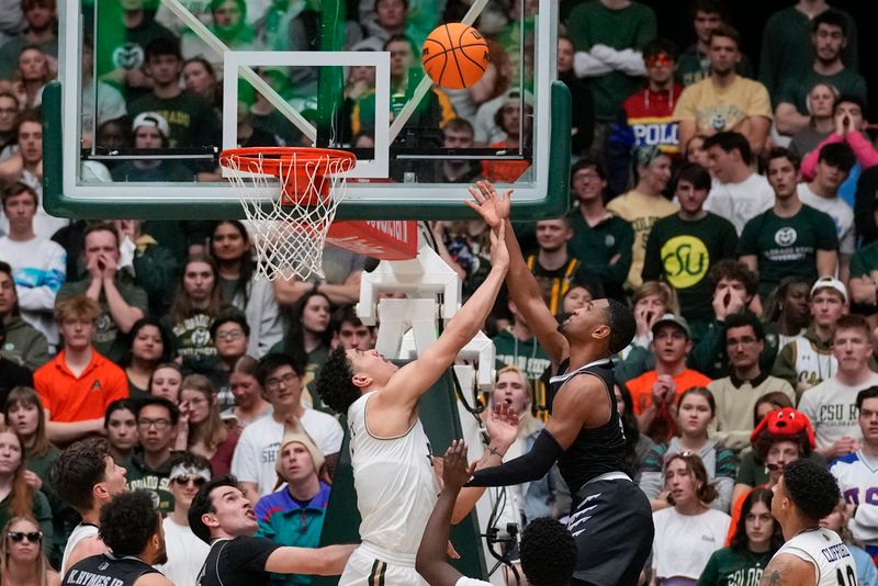 Feb 27, 2024; Fort Collins, Colorado, USA; Colorado State Rams forward Joel Scott (1) could Nevada Wolf Pack guard Hunter McIntosh (0) during the second half at Moby Arena. Mandatory Credit: Michael Madrid-USA TODAY Sports