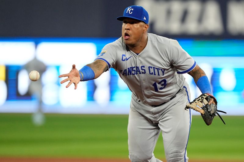 Sep 8, 2023; Toronto, Ontario, CAN; Kansas City Royals first baseman Salvador Perez (13) throws the ball to pitcher Austin Cox (not pictured) to try an get Toronto Blue Jays catcher Alejandro Kirk (not pictured) out at first base during the seventh inning at Rogers Centre. Mandatory Credit: John E. Sokolowski-USA TODAY Sports